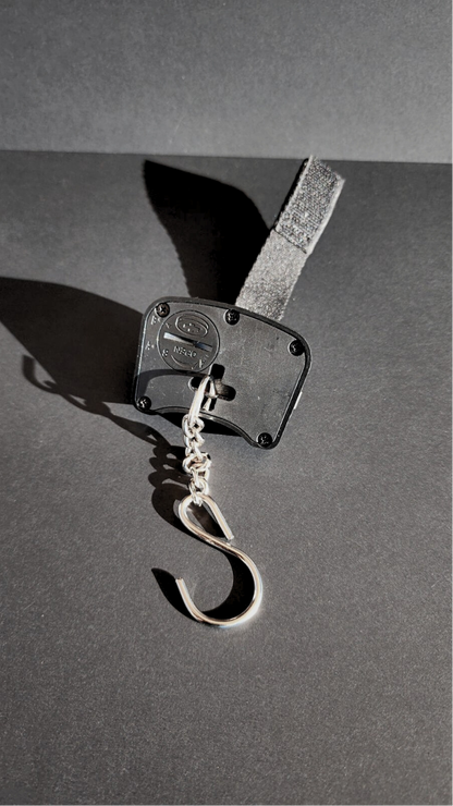 Metallic hook on a dark gray background